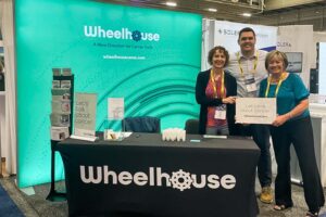Wheelhouse team at a tradeshow disrupting cancer's impact