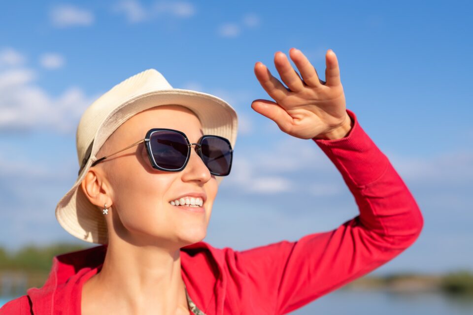 Young adult beautiful happy attractive caucasian bald shaved woman portrait in hat having fun enjoy