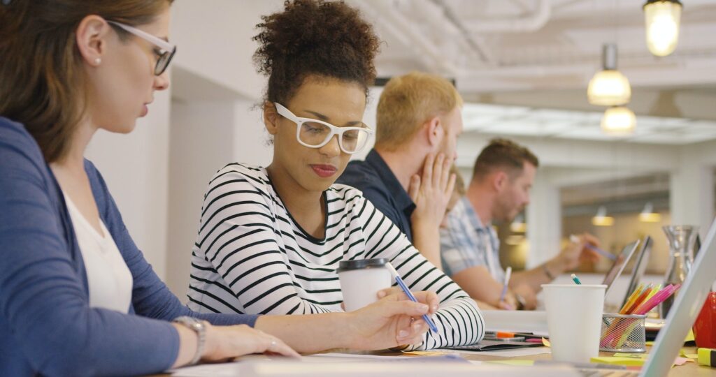 Employees working in team at table