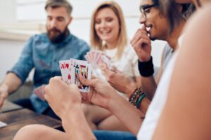 Group of friends playing cards - social connections